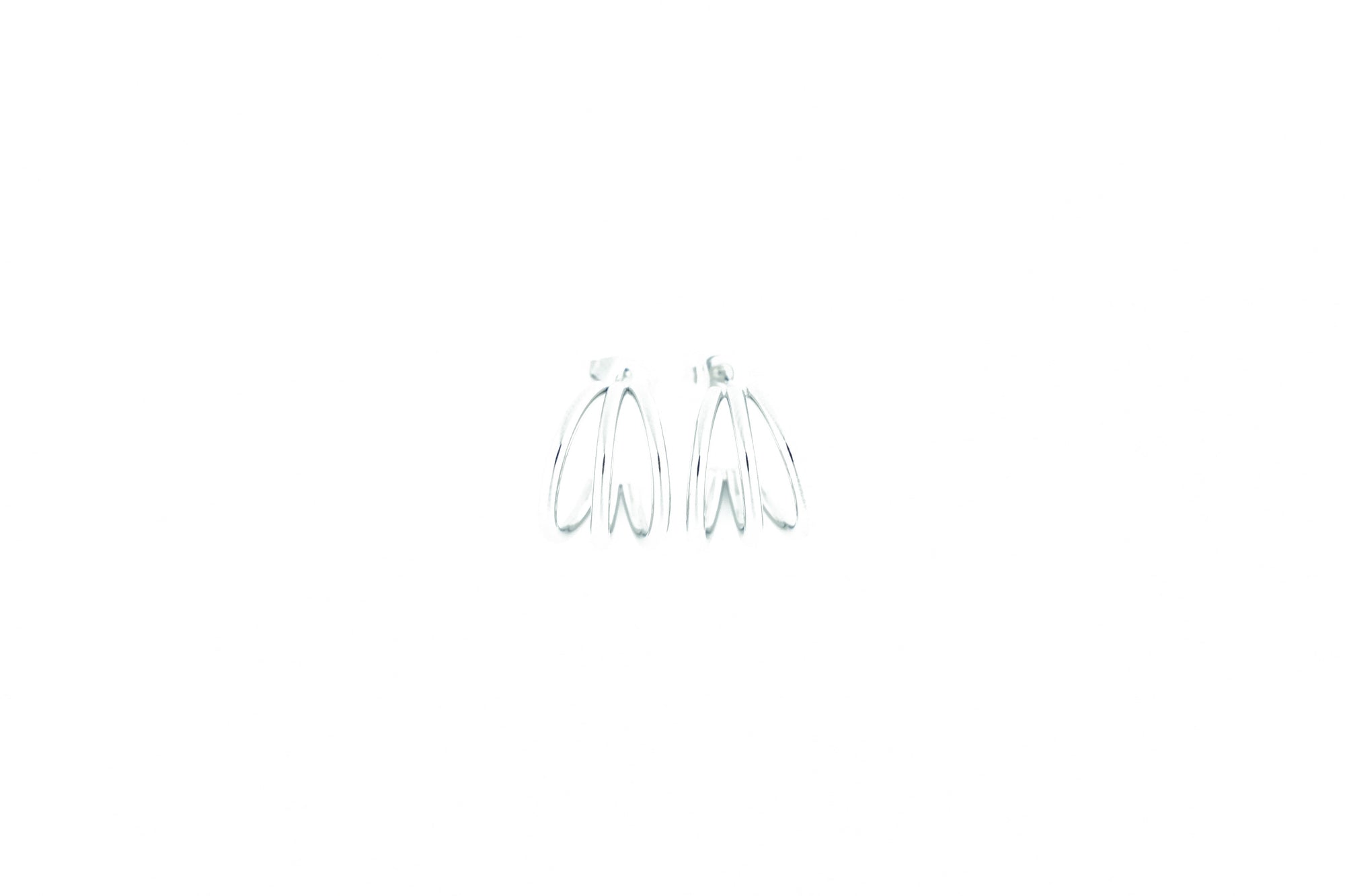 trendy silver colored earrings detail from design on earth
