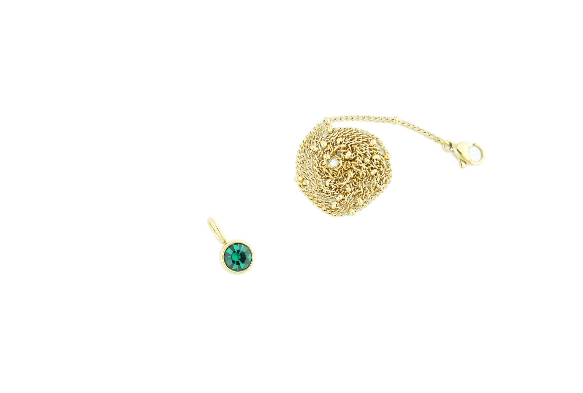 golden-colored chain with green stone perfect for party