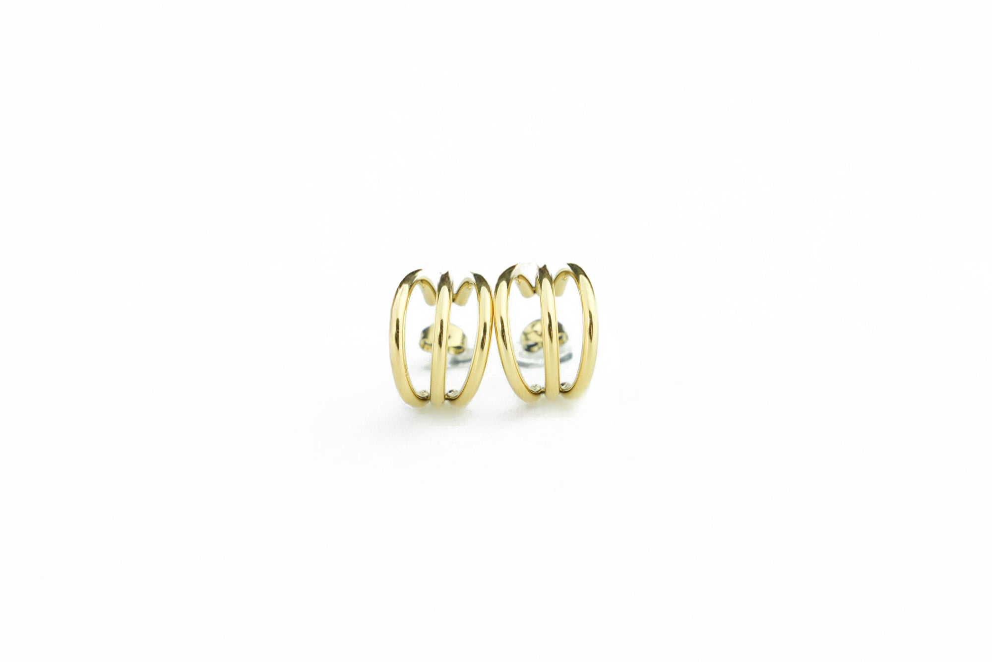 Side angle of a elegant gold colored earrings
